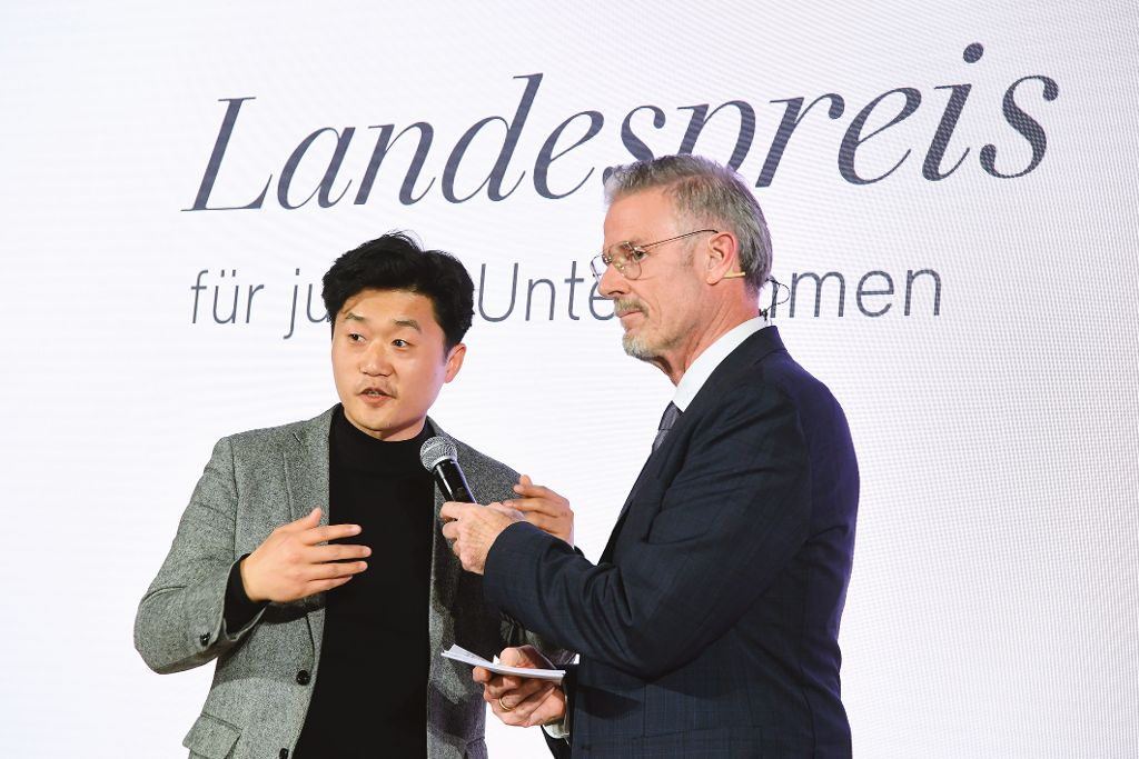 Ein Mann interviewt einen anderen Mann auf der Bühne der Landespreis-Preisverleihung.